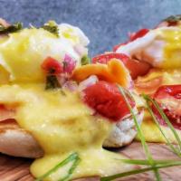 Salmon Benedict · Poached eggs, smoked salmon, English muffin, pico de gallo, hollandaise sauce, served with s...