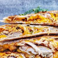 Pulled Spicy Chicken Quesadilla · Spicy chicken, cheddar cheese served with pico de gallo & sour cream.