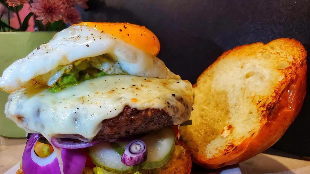 Bagutta Burger Deluxe  · 8oz angus beef served with smashed avocado, cheddar cheese, sunny side up egg, lettuce tomatoes onions pickles & French fries on a brioche roll