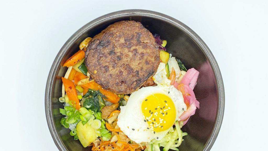 Beyond Burger Bibimbap · Beyond patty, assorted vegetables(zucchini, carrots, kale, mushrooms), pickled vegetables, served over steamed jasmine rice, sunny side up egg & spicy chili sauce on the side.