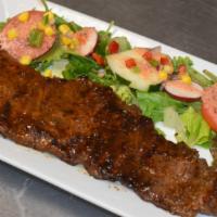 Skirt Steak / Churrasco · Skirt steak cooked to your liking topped with our house sauce.