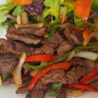 Pepper Steak / Bistec Salteado · Sirloin Steak strips sauteed with onions, red and green peppers, with a touch of garlic, ore...