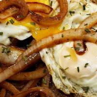 Sirloin Steak & Eggs / Bestec Al Caballo · A mouth-watering sirloin steak and onions topped with two fried eggs.