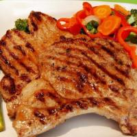 Grilled Pork Chops / Chuleta Parrilla · A pair of pork chops slowly grilled with a splash of fresh lime.