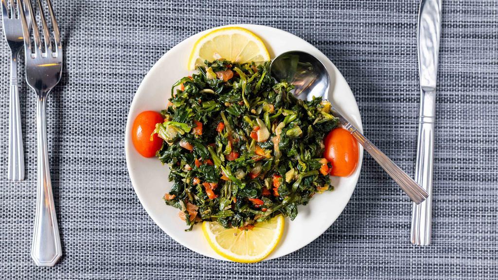 Spinach Sautéed · Sautéed spinach with tomatoes shallots and bell peppers.
