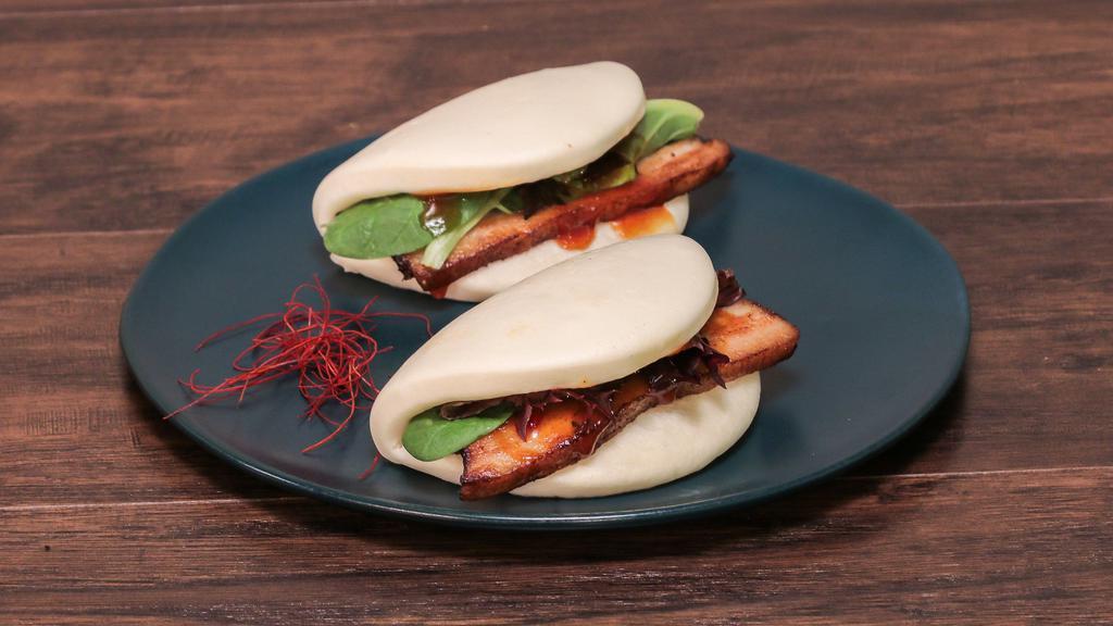 Chashu Buns · Soy braised pork belly served over a soft steamed bun and house made sauce.