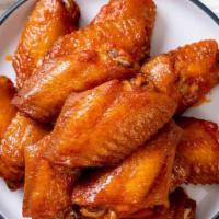 Buffalo Chicken Wings · Fresh chicken wings smothered in a house made tangy buffalo sauce.