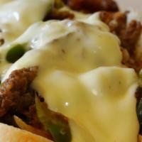 Philly American Cheese Steak Deluxe · Juicy meat, creamy American cheese, and sautéed onions and green bell pepper served between ...