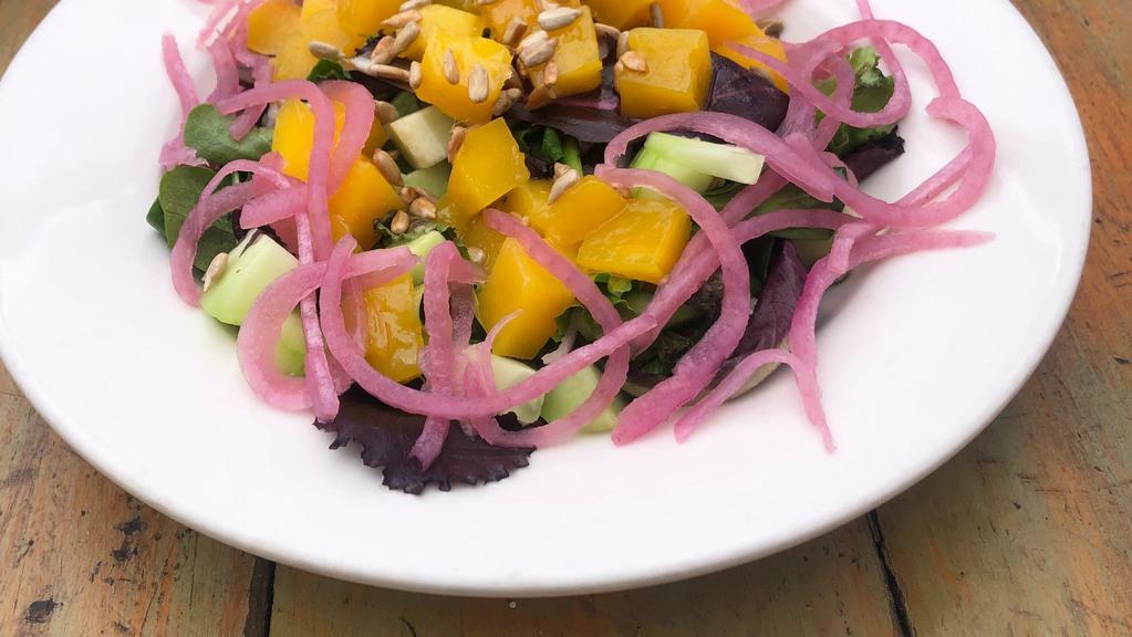 Fresh Mango Mixed Salad · Sliced mango, mixed greens, toasted sunflower seeds, cucumber, red onion with olive oil and a pinch of salt.