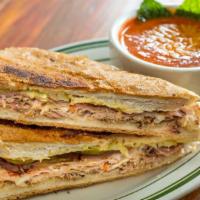 Cubano Sandwich · Slow roasted mojo-marinated pork, virginia ham, gruyere cheese, dill pickles and dijon musta...