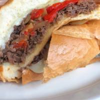 Pressed Philly Cheesesteak · Melt in your mouth. Hoagie bread, chopped steak, provolone cheese, roasted red peppers and c...
