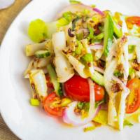 Yum Squid · Grilled fresh squid tossed with chili, lime juice, sweet onion, celery, and tomato.