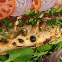 Whole Branzini (Mediterranean Sea Bass) · Char grilled to taste and served with garlic lemon sauce.