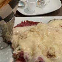 Open Faced Reuben · Served on toasted rye bread with sauerkraut and melted Swiss cheese.