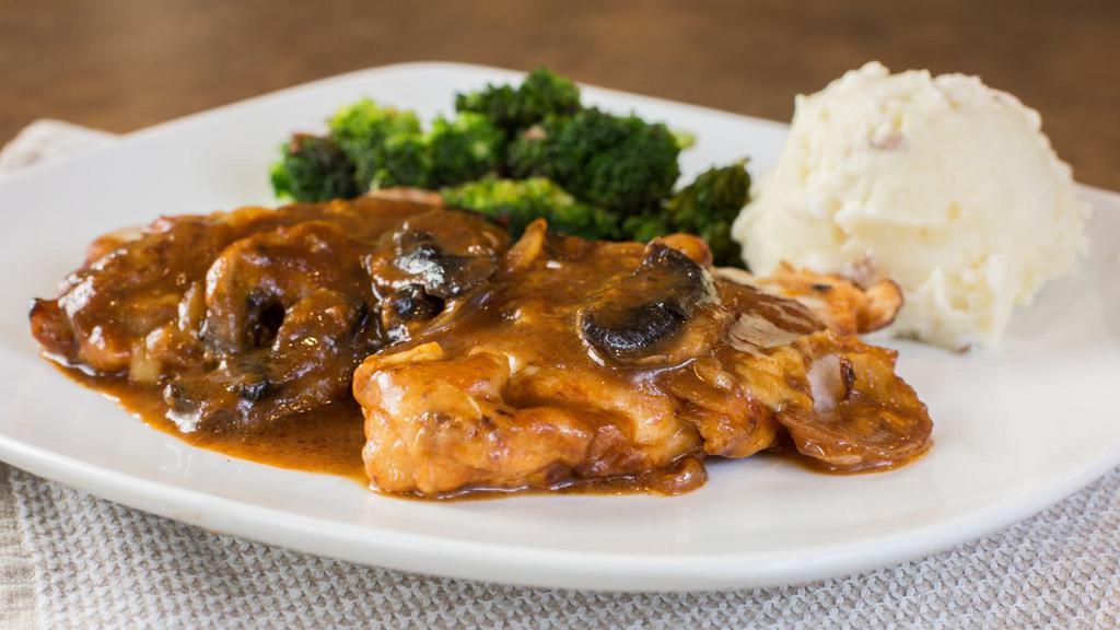 Chicken Madeira · Two chicken breasts sautéed with onions and mushrooms, topped with melted Mozzarella cheese, then simmered in Madeira wine sauce, served with mashed potatoes.