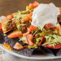 Nachos Supreme · Crispy tortilla chips topped with melted nacho cheese, chili sauce, chopped lettuce, tomatoe...