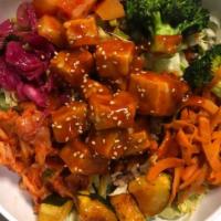 Spicy Korean Tofu Bowl · Served on a bed of rice and greens topped with fresh traditional kimchi, pickled daikon, roa...