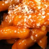 Spicy Korean Rice Gnocchi · Korea's most popular street food; crispy rice cake drizzled with Korean red pepper glaze, to...