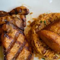 Grilled Pork Chops · Grilled pork chops. Yellow rice. Beans and sweet plantains.
