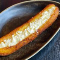Maduro Con Queso · Whole Sweet plantain and melted queso fresco on top