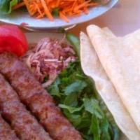 Has Has Kebab · Skewered ground meat on a bed of special homemade fresh tomato sauce.