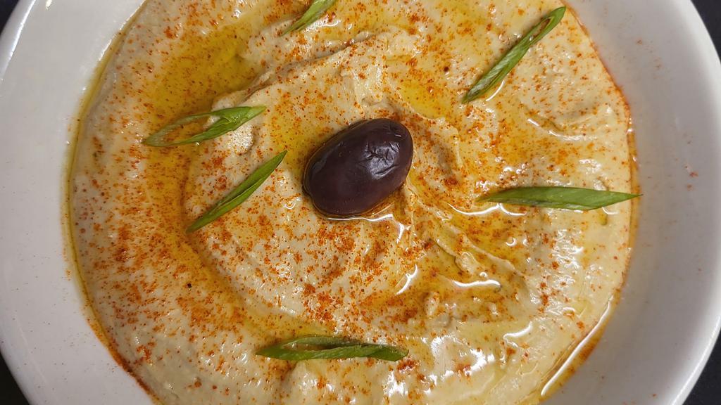 Hummus · Mashed chickpeas with tahini, cumin, and garlic.