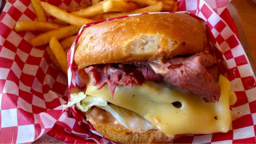The Pastrami Cheeseburger · Fresh ground beef patty, creamy cheese, and hot savory pastrami with your choice of condiments stuffed in between a fresh baked bun.