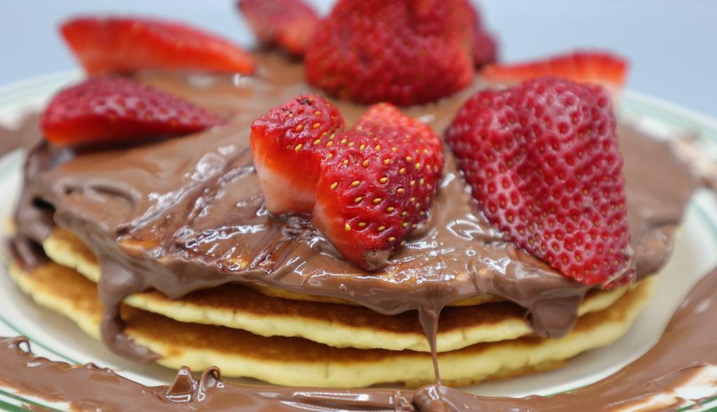 The Nutella Pancakes · Topped with Nutella and strawberries
