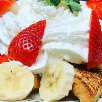 Corner French Toast · Strawberries, banana, and whipped cream dusted with sugar and cinnamon.