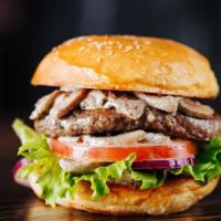 Mushroom Swiss Cheeseburger · Sizzling beef patty topped with grilled mushrooms, onions, Swiss cheese, tomatoes, and pickl...