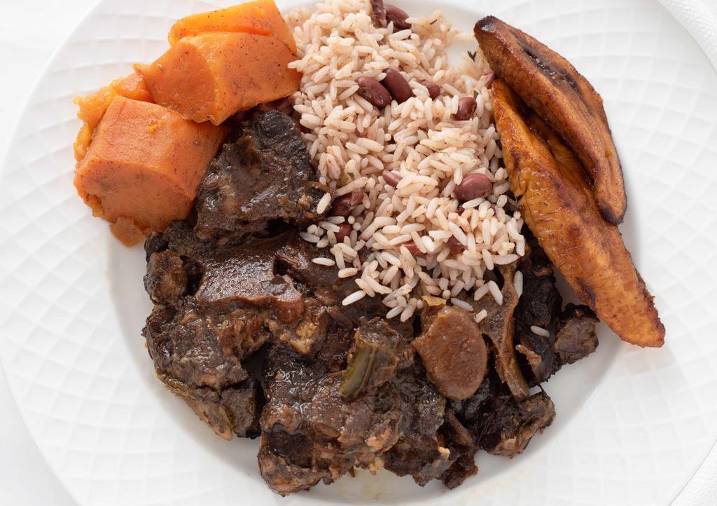 Oxtail · Braised and slowly simmered with herbs and butter beans. Served with rice and peas, white rice or yellow rice and choice of macaroni and cheese, a garden salad, sautéed cabbage carrots, potato salad, candid yams or collard greens.