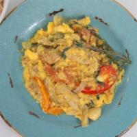 Ackee And Salt Fish · Salt fish and ackee sautéed with onions, tomatoes and peppers. Served with rice and peas, wh...