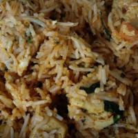 Chicken Biryani · Chicken and rice cooked together with curry sauce.
