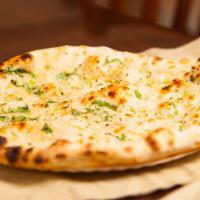 Garlic Naan · Leavened bread of super fine flour with garlic baked in a clay oven.
