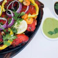 Tandoori Chicken · Punjabi style spring chicken marinated in yogurt, freshly ground mild spices and lemon juice...