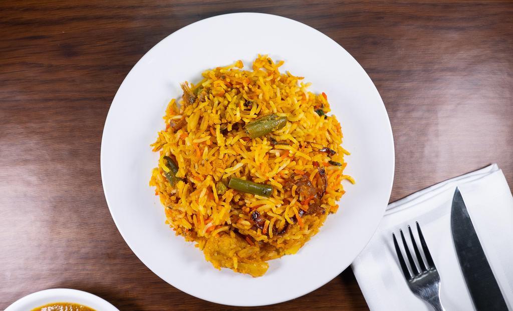 Vegetable Biryani · Long grain basmati rice cooked with fresh vegetables and saffron sprinkled with raisins and nuts.