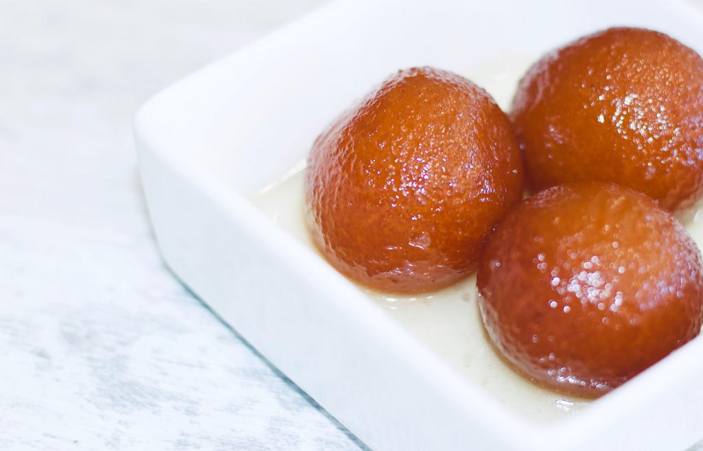 Gulab Jamun · Juicy fried cheese ball dipped in honey syrup.