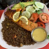 Haitian Rice With Grilled Salmon · Wild caught grilled salmon over a bed of black 'jou jou' rice and a garden salad on side