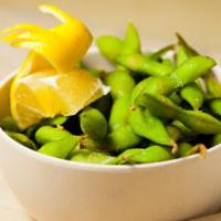 Edamame · Steamed edamame pods, salted, and served with a wedge of lemon.