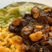 Oxtails · slowly  stewed and cooked to perfection/your choice of 2 sides