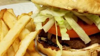 Cheeseburger With French Fries · freshly ground burger topped w cheese lettuce and tomatoe  on the side of steak fries