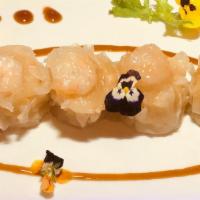 Gourmet Shrimp Shumai · steamed jumbo shrimp dumpling with crystal baby shrimp on top . dipping sauce on the side.