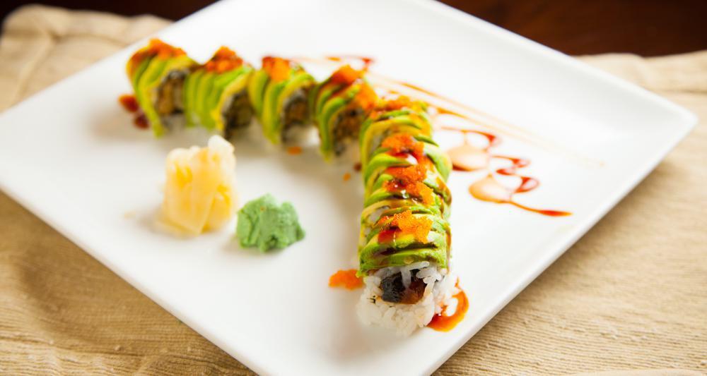 Dragon Roll · Eel and cucumber roll, avocado and tobiko on top and dress with chef's special sauce.