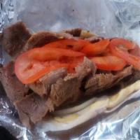 Gyro 100% Beef Pita · 100% Beef Gyro in a pita bread with tomatoes and onions. Choice Tzatziki or Red Onion sauce.