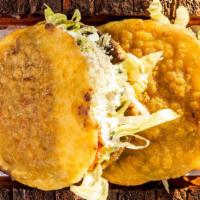 Gorditas De Chicharrón (2) · Two fried homemade stuffed masa with chicharrón inside. Stuffed with beans, lettuce, pico de...