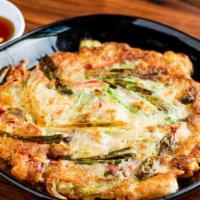 Seafood Pancake · Mixed seafood (mussels, shrimp, calamari), scallion, onion, peppers. Served with ponzu sauce.