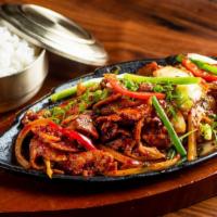 Jeyuk Kimchi Bokum · Hot. Spicy pork with kimchi, onion, peppers, scallion, and mushroom on sizzling pan served w...