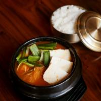 Kimchi Chigae · Korean style kimchi stew with pork and tofu served with rice, meat broth.