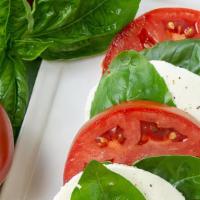 Insalata Caprese · Sliced fresh mozzarella and tomatoes drizzled with an herb-infused olive oil.