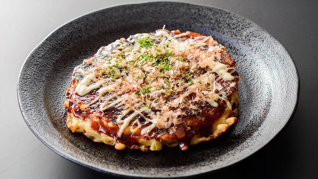 Okonomiyaki / 大阪烧 · Japanese Style pan-fried pancake topped with okonomiyaki sauce, mayonnaise, bonito flakes (katsuobushi), dried green seaweed (aonori).